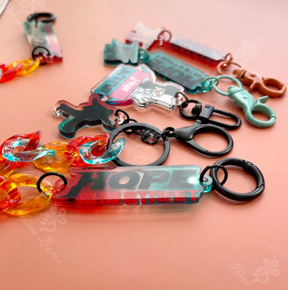 Our BTS Jhope OnTheStreet Keychain! A perfect pendant accessory for your bag, mobile, or phone, made from high-quality acrylic. Color decorative piece inspired by Hobi's unique style.