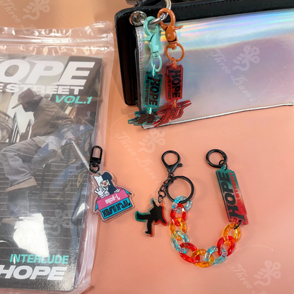 Our BTS Jhope OnTheStreet Keychain! A perfect pendant accessory for your bag, mobile, or phone, made from high-quality acrylic. Color decorative piece inspired by Hobi's unique style.